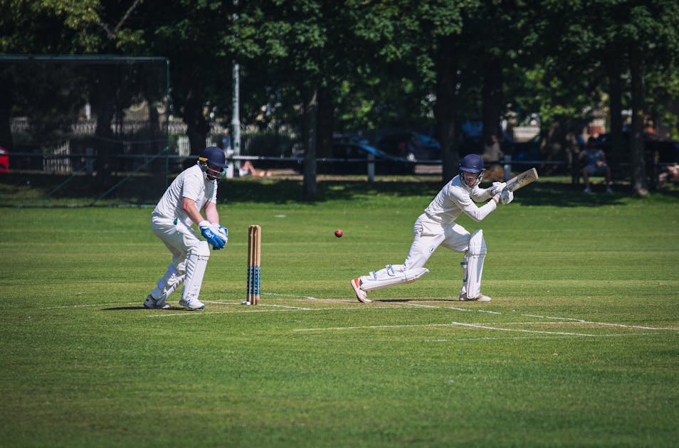 Cricketers talking at the boundary during a local match